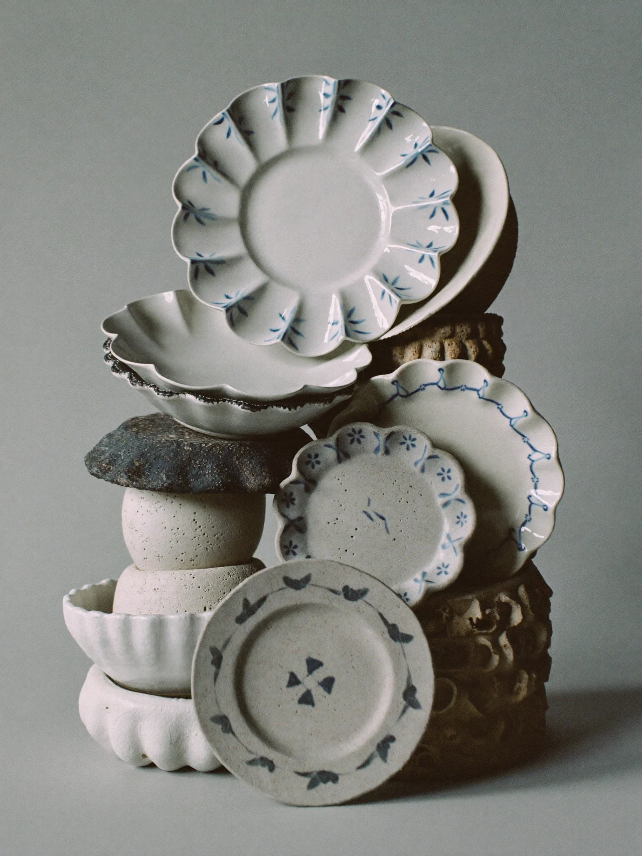 Pale ceramic dishes balanced in a sculptural arrangement